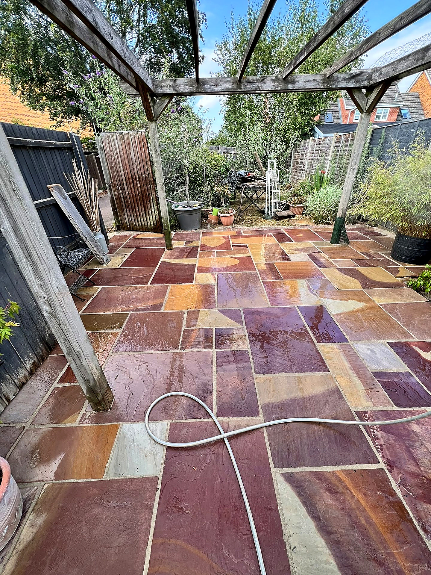 Sandstone patio under a pergola freshly cleaned by Mr Pressure Clean Exterior Solutions