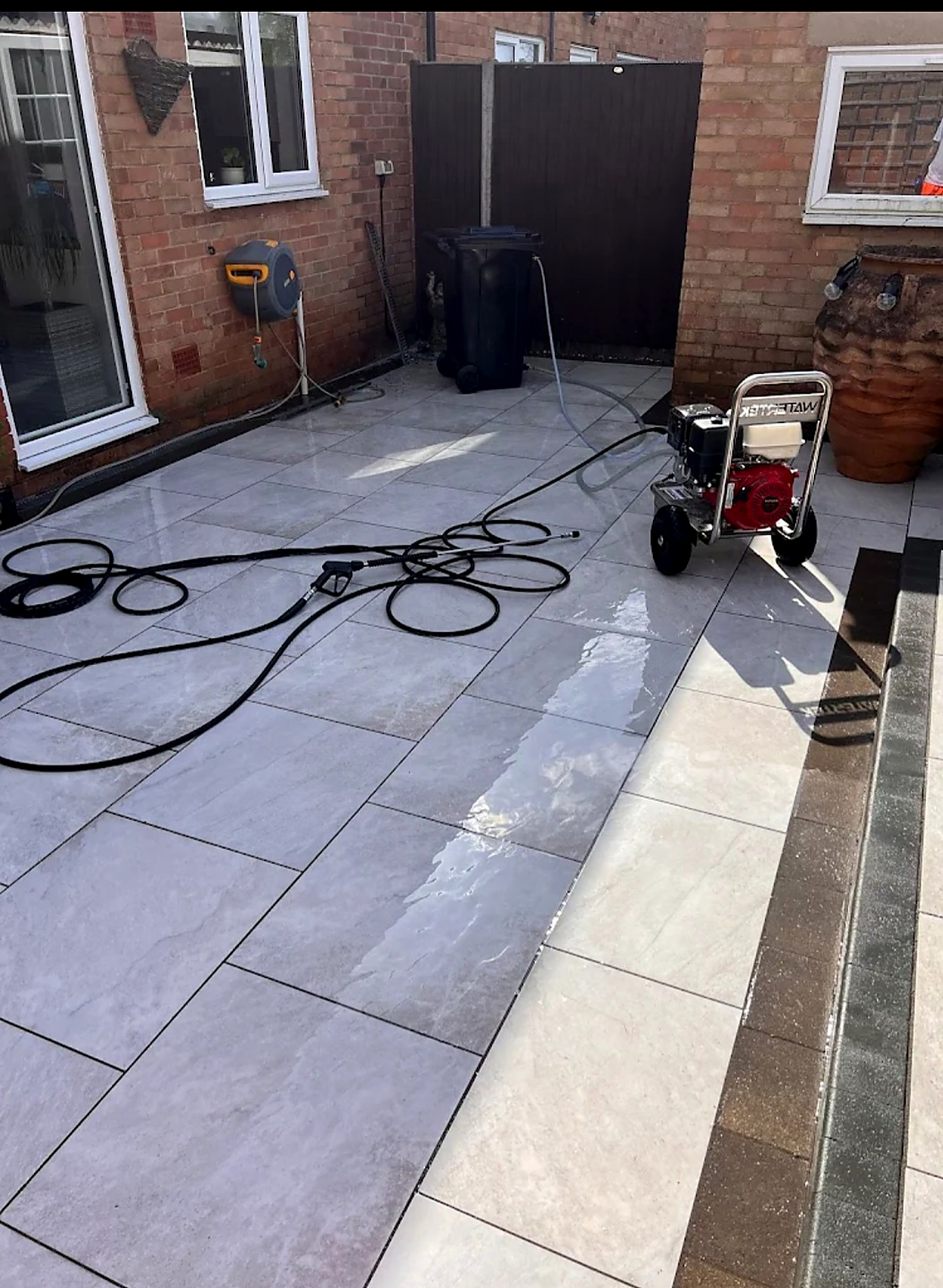 Porcelain patio being pressure washed