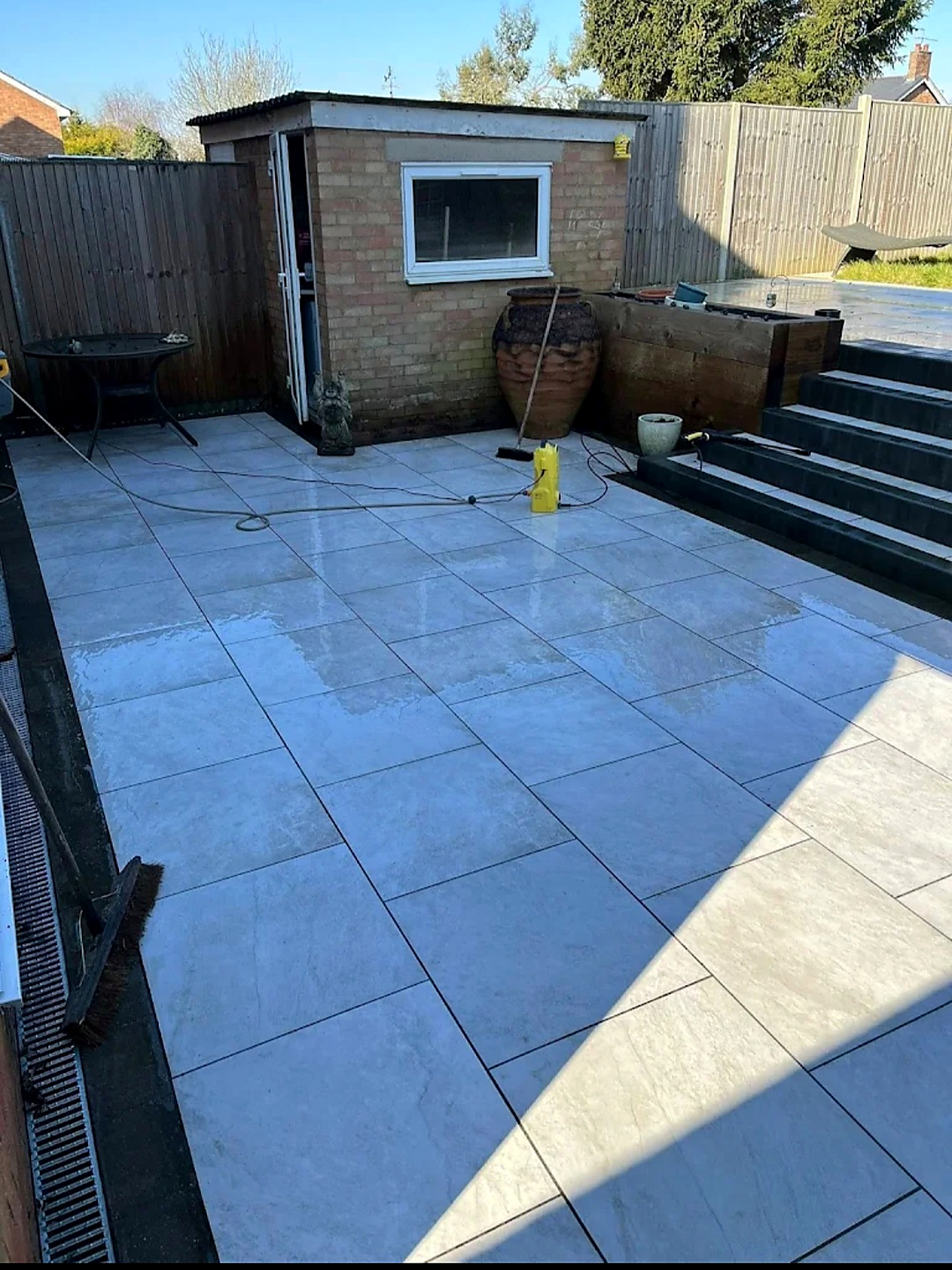 Large grey porcelain tiled patio after a deep clean