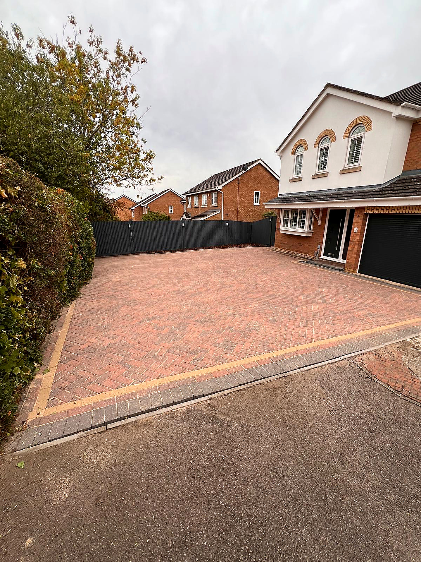 Block paved driveway before and after professional pressure washing — after